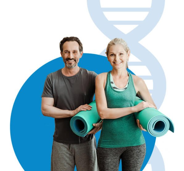 Active couple holding yoga mats